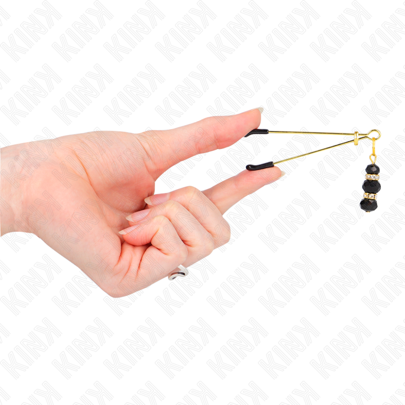 KINK – Pincette à tétons dorées avec ornements bijoux noirs
