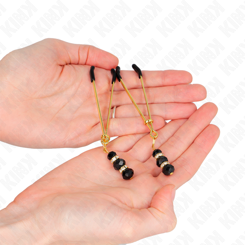 KINK – Pincette à tétons dorées avec ornements bijoux noirs